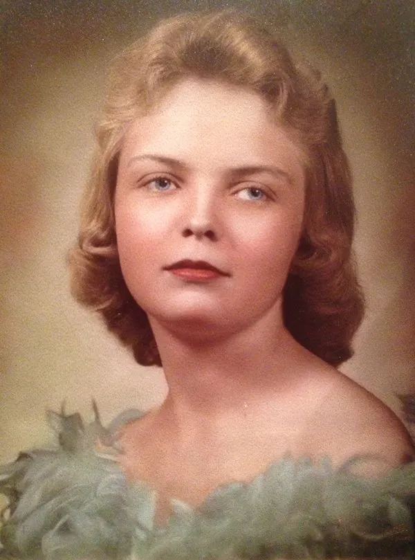 Portrait of a young woman with soft curls and a gentle expression.